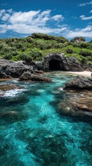 Tropical cove with vibrant turquoise water, dark rocky outcrops, and lush green vegetation under a bright, cloudy sky