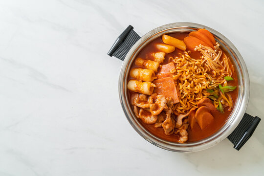 Budae Jjigae or Budaejjigae (Army stew or Army base stew). It is loaded with Kimchi, spam, sausages, ramen noodles and much more