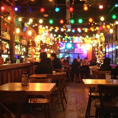 Warm, dimly lit bar with colorful lights, people seated at tables