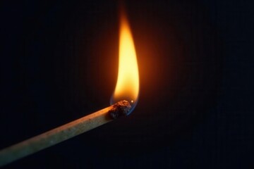 Close-up of a flickering match flame against dark background, bonfire, ignition, caution