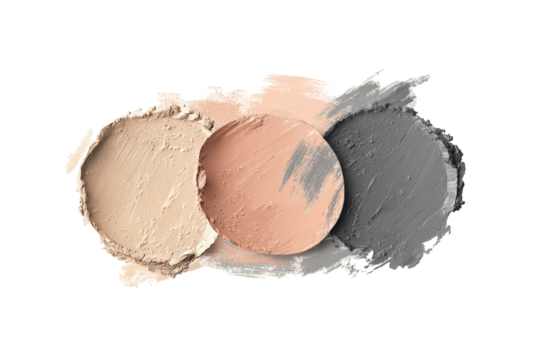 Three shades of makeup product, light beige, blush, and gray, smudged together
