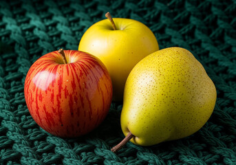 Vibrant apples and pear on dark green knit