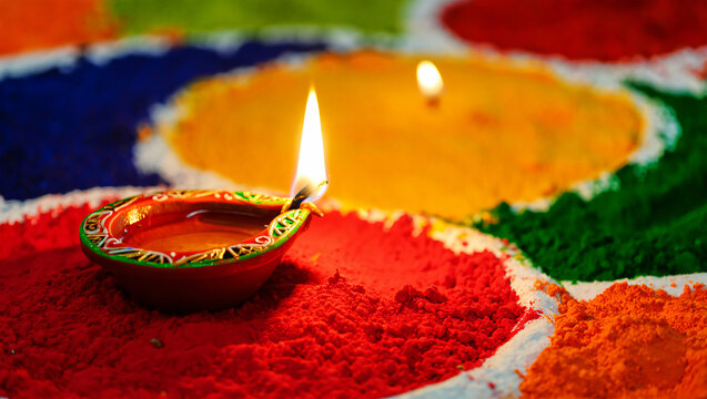 Diwali Oil Lamp Lit Amidst Colorful Rangoli Powder a100 488a