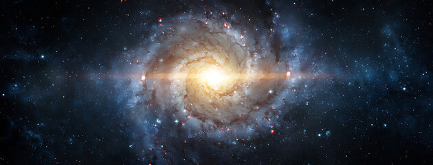 Obraz premium A breathtaking view of a spiral galaxy with its bright central bulge and swirling arms extending into the vast darkness of space populated by countless distant stars 