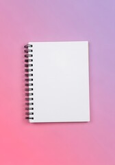 Blank spiral notebook resting against colorful gradient background space