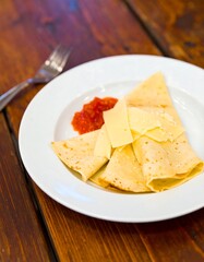 Crepes with cheese and sauce on a plate