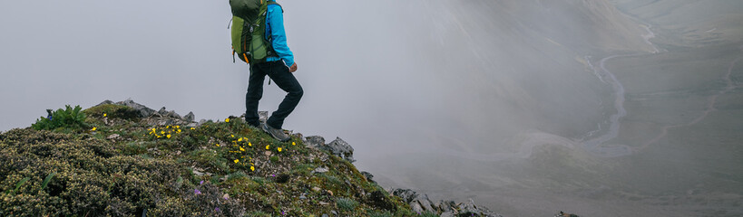 Woman hiker backpacking on mountain top