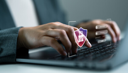 Close-up of hands typing on laptop with secure login and cybersecurity shield icon, data...