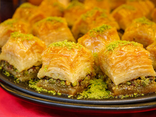 A close up of a serving plate filled with pistachio baklava pieces a traditional and much loved sweet pastry known for its rich flavor and flaky texture
