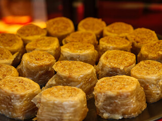 A display of sweet pastries with a crunchy nut filling a traditional dessert that is rich in flavor and texture