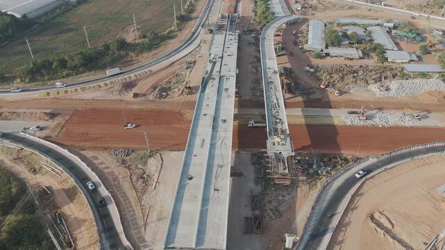 Aerial view drone footage of bridge construction being made across the intersection