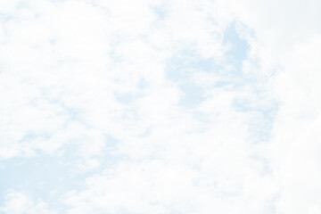 Overcast sky with thick gray clouds stretching across the horizon, creating a calm yet moody atmosphere above a distant landscape.