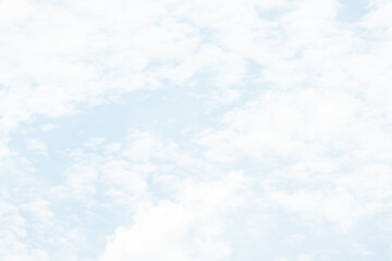 Overcast sky with thick gray clouds stretching across the horizon, creating a calm yet moody atmosphere above a distant landscape.