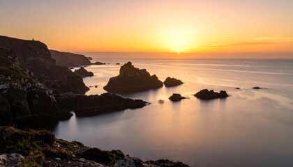 Coastal sunrise over rocky outcrop