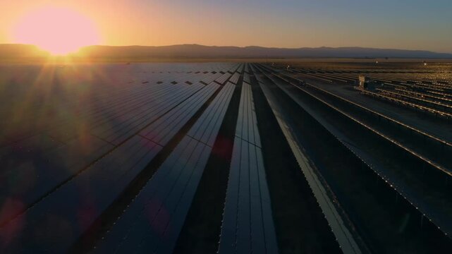Aerial view of a vast solar panel farm in Santa Margarita, California, USA, at sunset. The panels generate clean, renewable energy, contributing to a sustainable future.