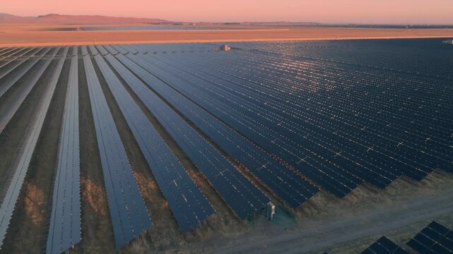 Aerial view of a vast solar panel farm in Santa Margarita, California, USA, at sunset. The panels generate clean, renewable energy, contributing to a sustainable future.
