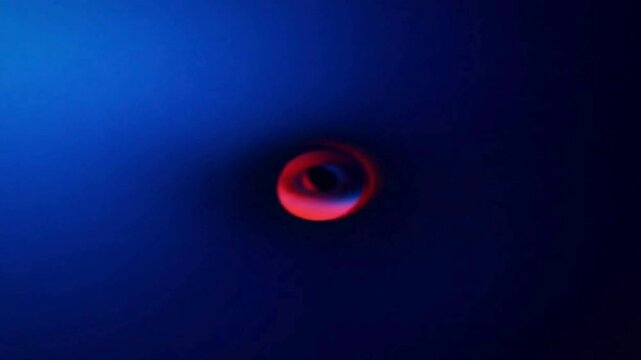 Blurred red ring floating in dark blue space, ideal for science fiction graphic designs and outer spacethemed projects. Suitable for book covers, website headers, or social media posts.