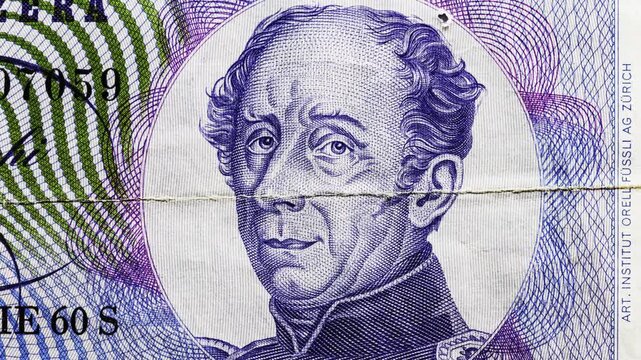 Macro pan of a circulated Swiss 20 francs note showing paper texture, folds and wear