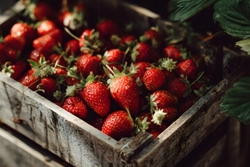a pile of strawberries sitting on top of a wooden table