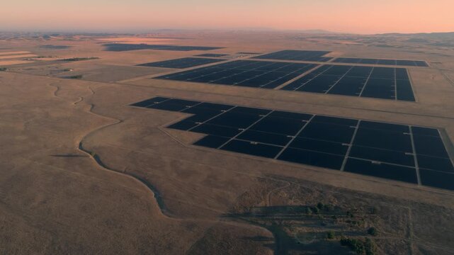 Aerial view of a large solar farm in Santa Margarita, California, USA. The panels are arranged in rows and columns, generating clean, renewable energy from the sun.