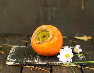 Persimmon on rustic wooden board