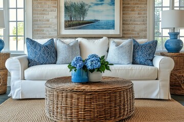 French country, farmhouse home interior design of modern living room. Wicker round coffee table near white sofa with blue pillows against beige brick wall with poster frame, Generative AI