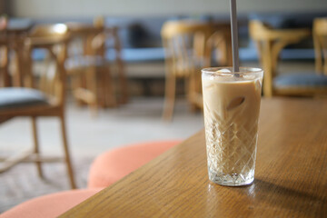 Refreshing iced drink on a wooden table in a cozy cafe