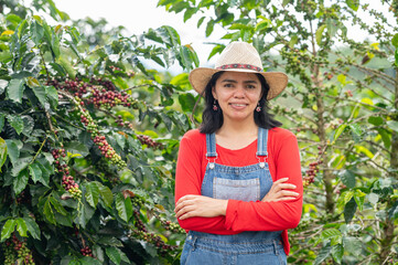 Colombian coffee farmer posing with crossed arms in a plantation