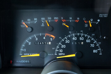 1990s full size American 4x4 SUV with 5.7L V8 interior dashboard and instrument cluster, showing analog gauges, odometer, climate controls, switches, and classic design details