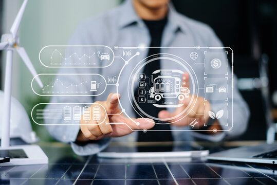 Engineer managing smart EV truck interface for clean logistics. Dashboard shows battery, solar, wind, CO2, and fleet icons in futuristic eco-transport tech network.