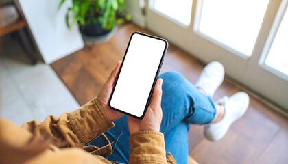 Person holding phone in a home