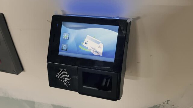 Electronic card reader with screen and backlit, graphic shows where to place the card. Contactless payment