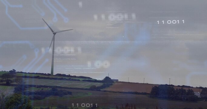 Towering wind turbine standing on ridge on farmland with hedgerows and circuit overlay, copy space