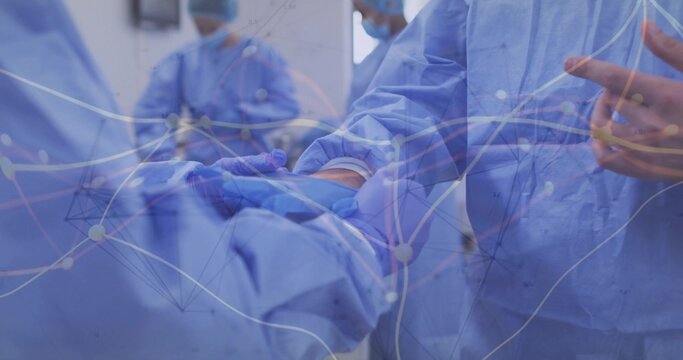 Passing scalpel between gloved hands over draped patient in operating room, with network overlay - Powered by Adobe