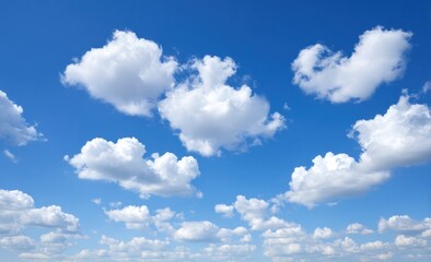Puffy white cumulus clouds drift across a bright, vivid blue sky. Sunny day aerial perspective features airy, light textures