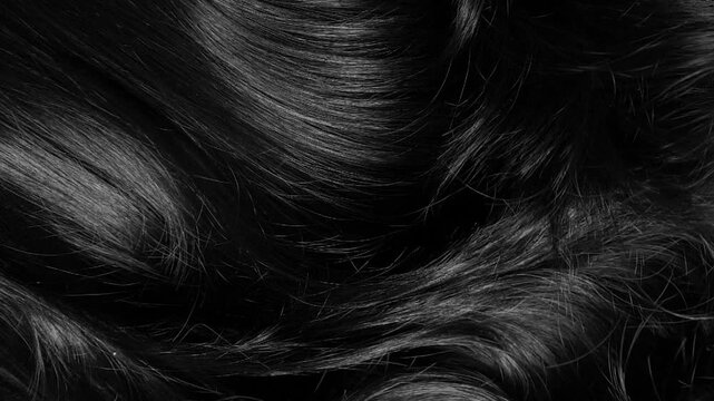Closeup beautiful female black long curly hair texture background in slow motion