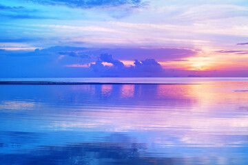 Sea beach sunrise, calm ocean sunset, beautiful peaceful dawn on tropical island, tranquil morning landscape, colorful pink purple sky, golden sun reflection on blue water, relax summer holidays, trav
