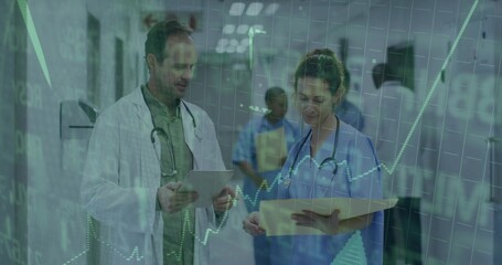 Walking male doctor holding tablet and nurse reading file in hospital corridor with data overlay