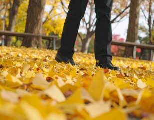Person walking on a carpet of autumn leaves