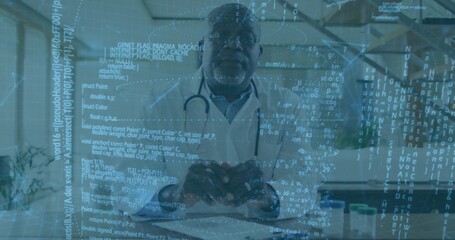 Senior doctor holding red heart model and demonstrating digital health informatics at clinic office