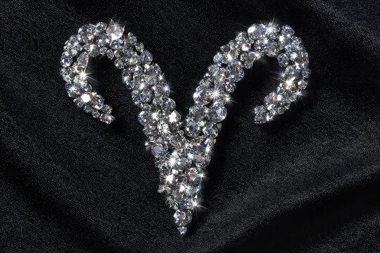Shiny Crystal Ram Symbol Embellishment on Dark Satin Background