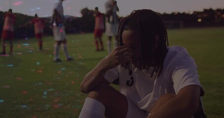Crouching soccer player pressing forehead on grass field, showing white jersey number 3, copy space
