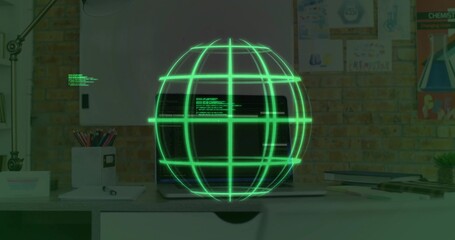 Floating green globe above laptop keyboard with visible code in home office with lamp and pencils
