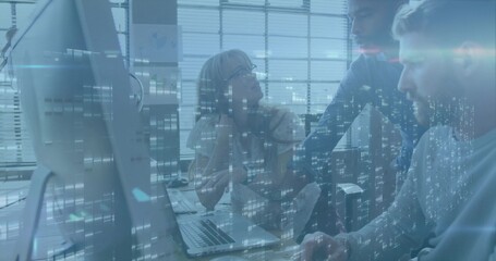 Collaborating professionals reviewing data on monitor and laptop in office with code overlay