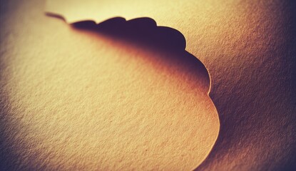 Close-up of textured, light brown paper with a sculpted, scalloped edge