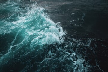 Fototapeta premium Turquoise Waves Crashing on Dark Ocean Surface at Dusk