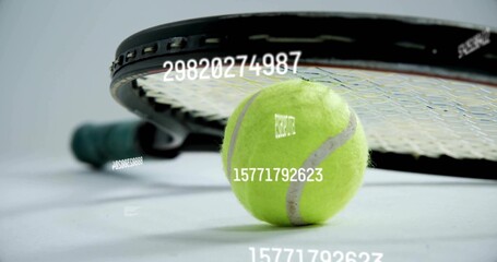 Green tennis ball resting on studio floor, with tennis racket and floating numeric overlays