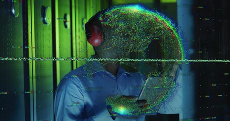 IT engineer wearing red headset analyzing data on tablet in server room, with holographic globe