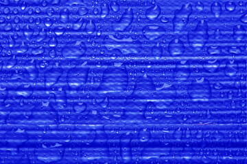 Close-up of strips of blue duct tape, or gaffer tape, background with water droplets on top. Strong waterproof industrial tape concept