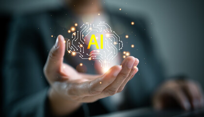 Businessperson holding glowing digital brain with text AI. Artificial intelligence, smart technology, digital brain, machine learning and business innovation.